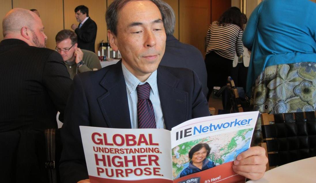 Photo: Man reading IIENetworker Magazine