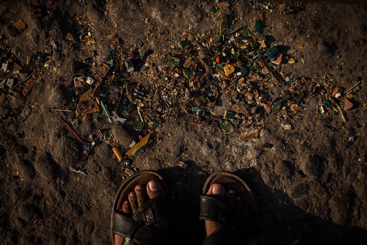 small pieces of broken electronics are seen everywhere on the soil at Nimtoli e-waste market, Dhaka.