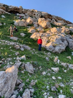 Children climb a rocky hill in the West Bank