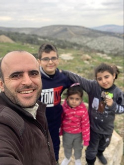 Abdelhaleem Khader and children take a picture in the hills of The West Bank