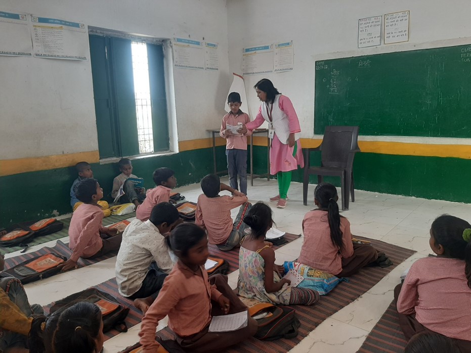 Dr. Anupma teaching students with individual attention in a primary school in Bednapur; Block Nakaha, District Lakhimpur Kheri.