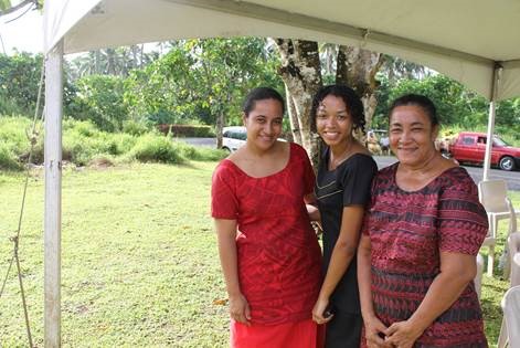 Darriel McBride under tent with her host family in Samoa