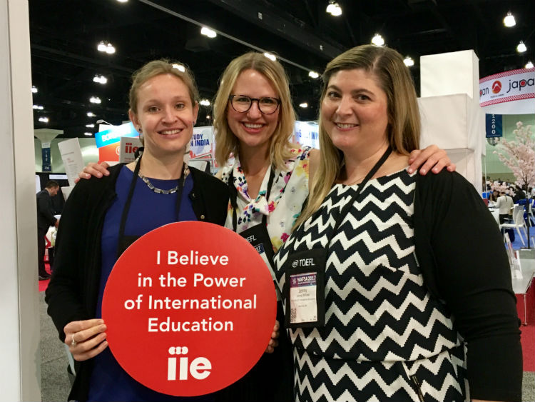 IIE staff at NAFSA holding sign