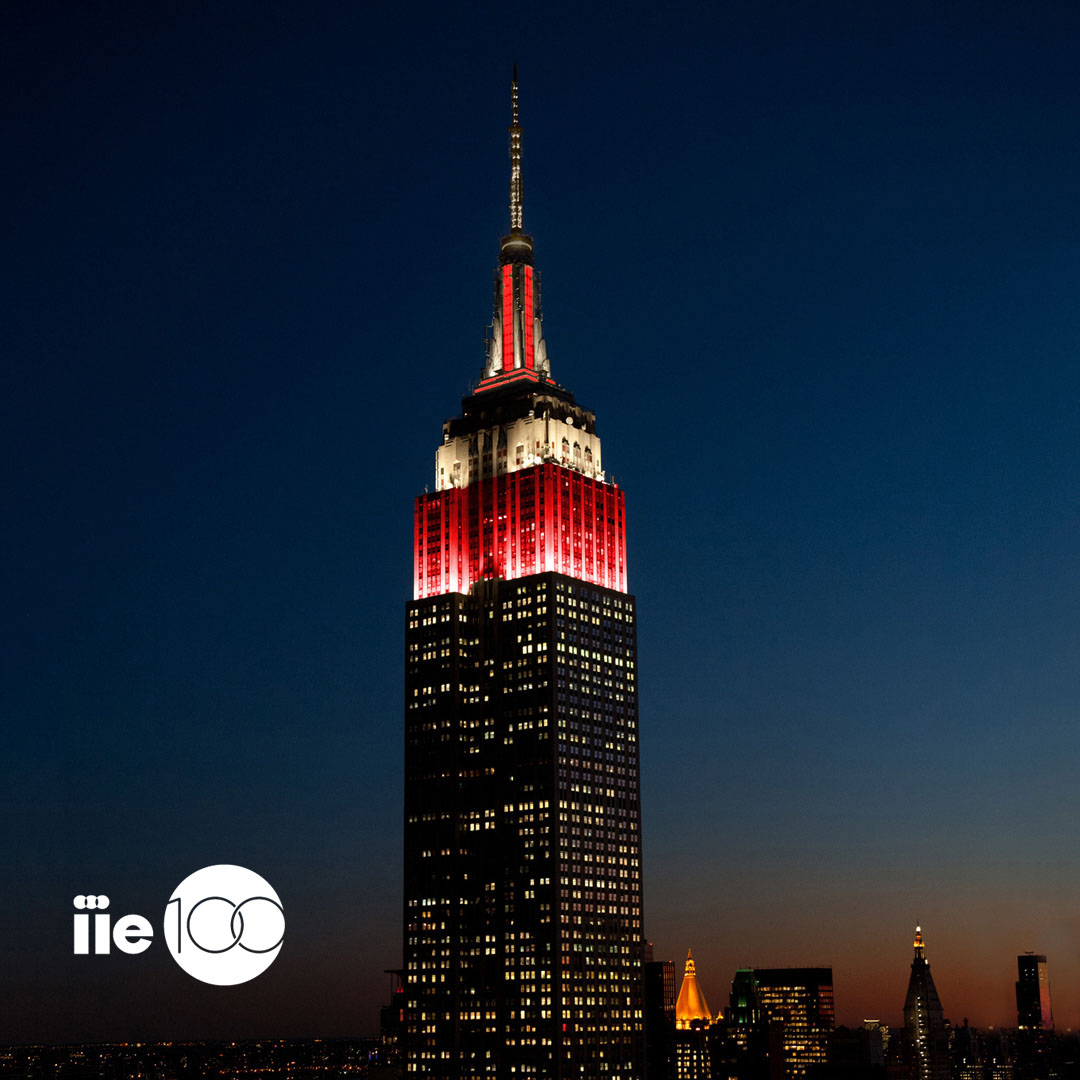 Empire State Building in White and Red with IIE 100 Logo