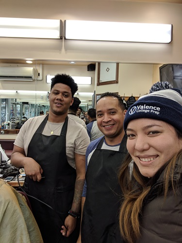 Krizia Lopez (far right) at barber shop