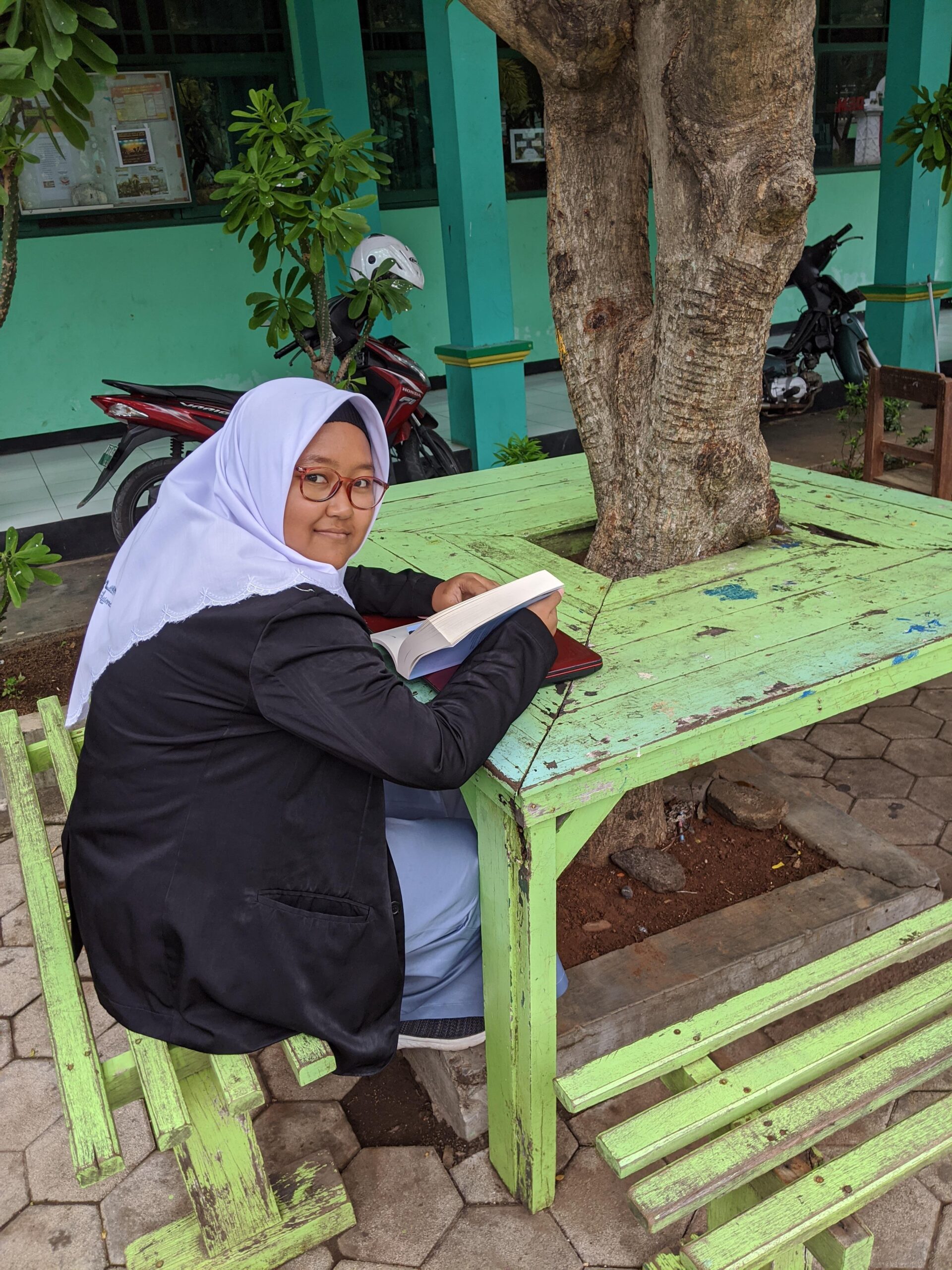 Female student reading outdoors