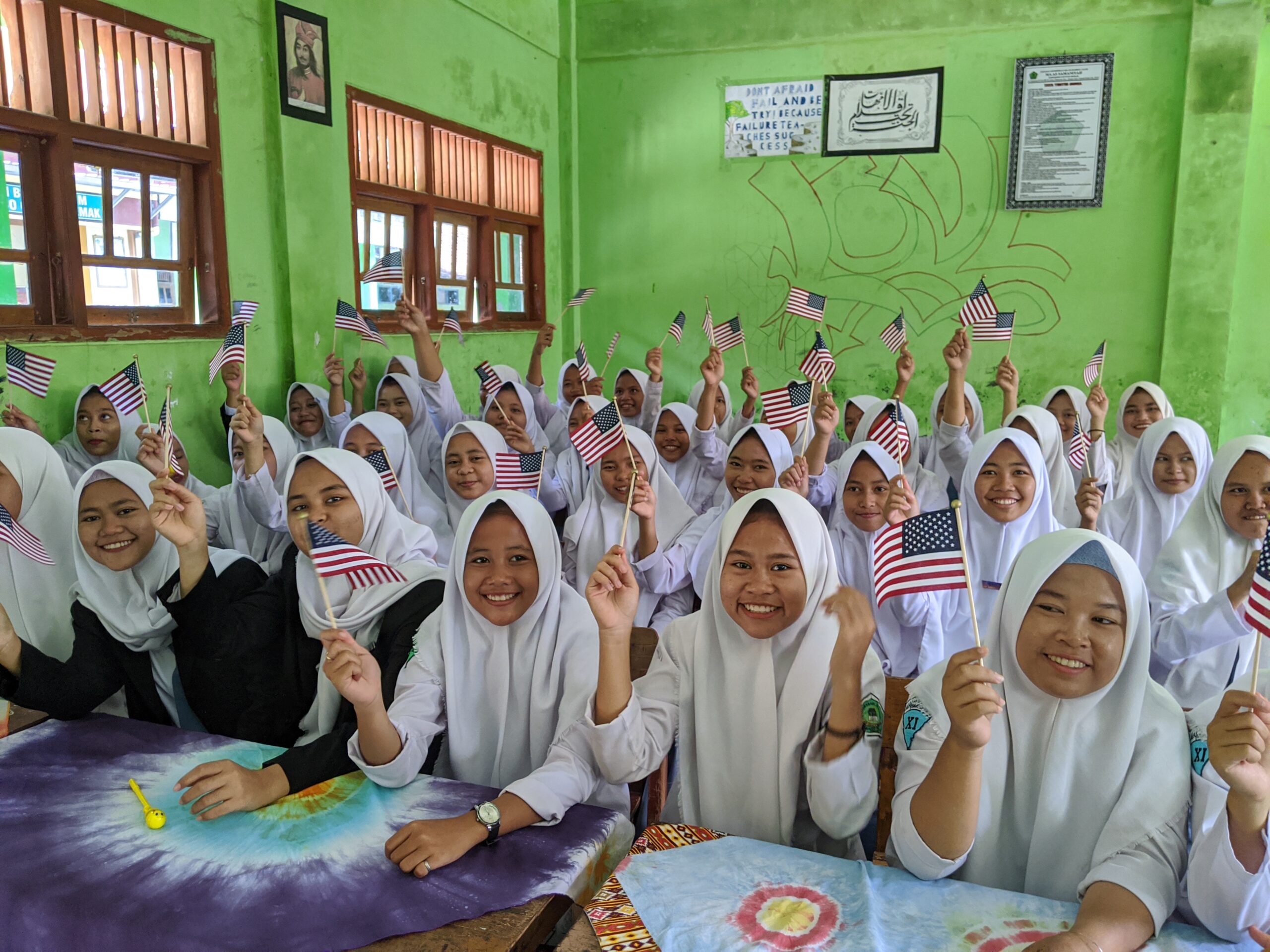 Female students wave American flags