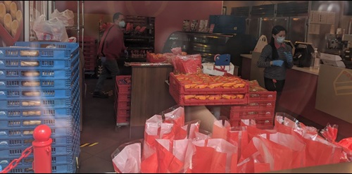 Red bags full of groceries in food pantry