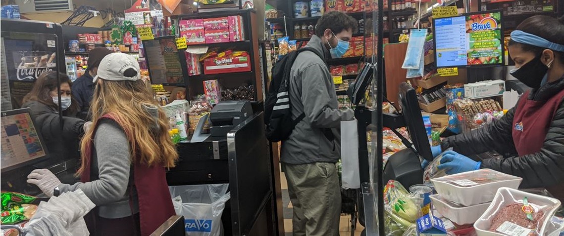 People wearing medical masks shop at a grocery store