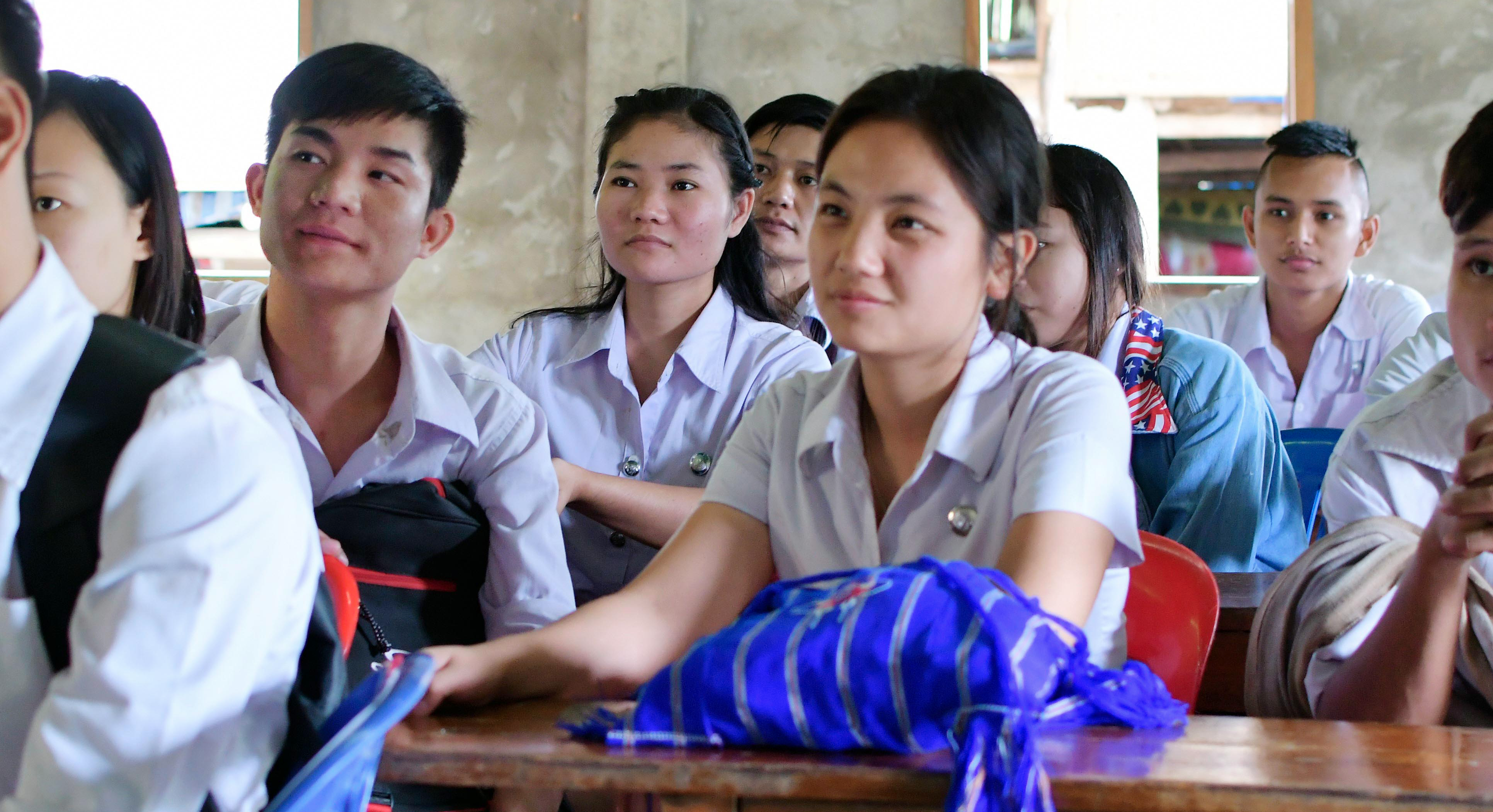 Displaced students from Myanmar study in a classroom in Thailand.