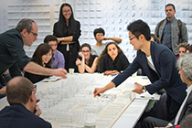 Group of people looking at architectural mockup