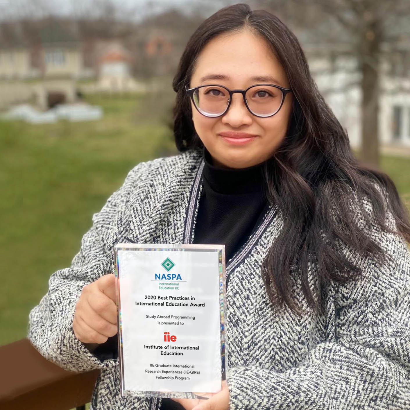 Sylvia Jons, Lead of Global Fellowships and Programs, holds NASPA's 2020 Best Practices in International Higher Education Award that was awarded to the IIE-GIRE program.