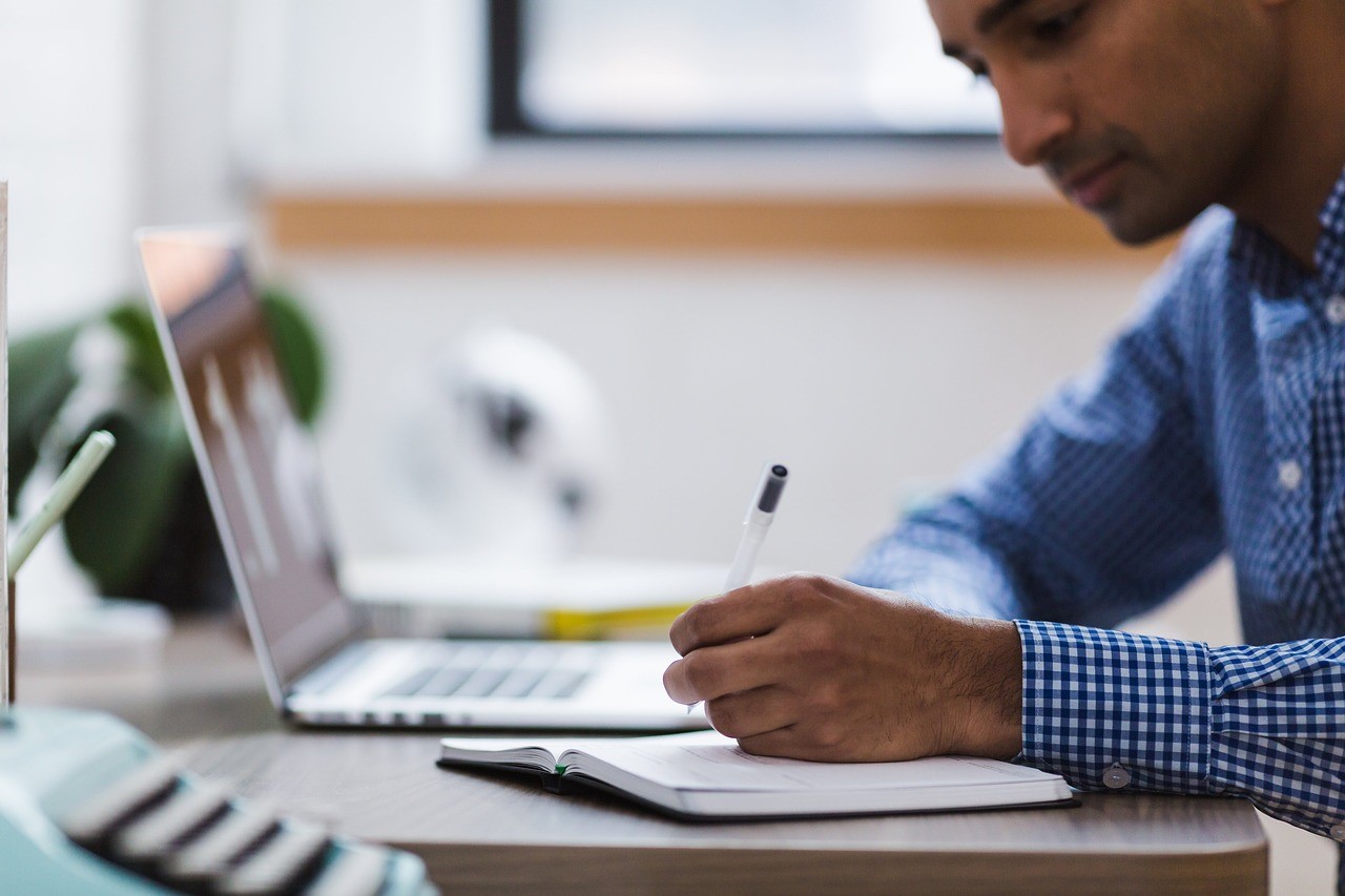 Man writing in notebook