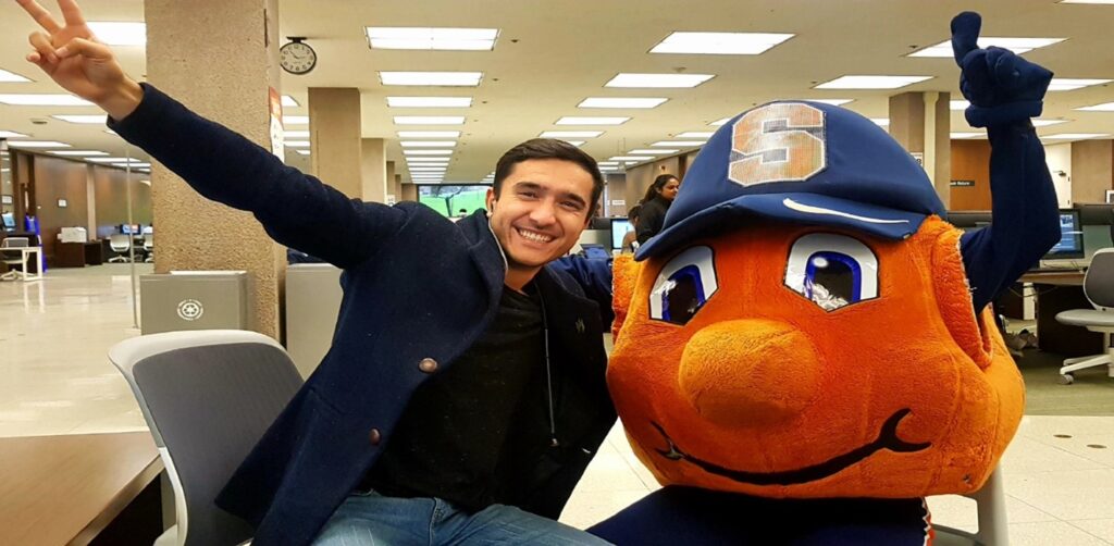Lutfullo Tagoev poses with Otto the Orange, mascot for Syracuse University