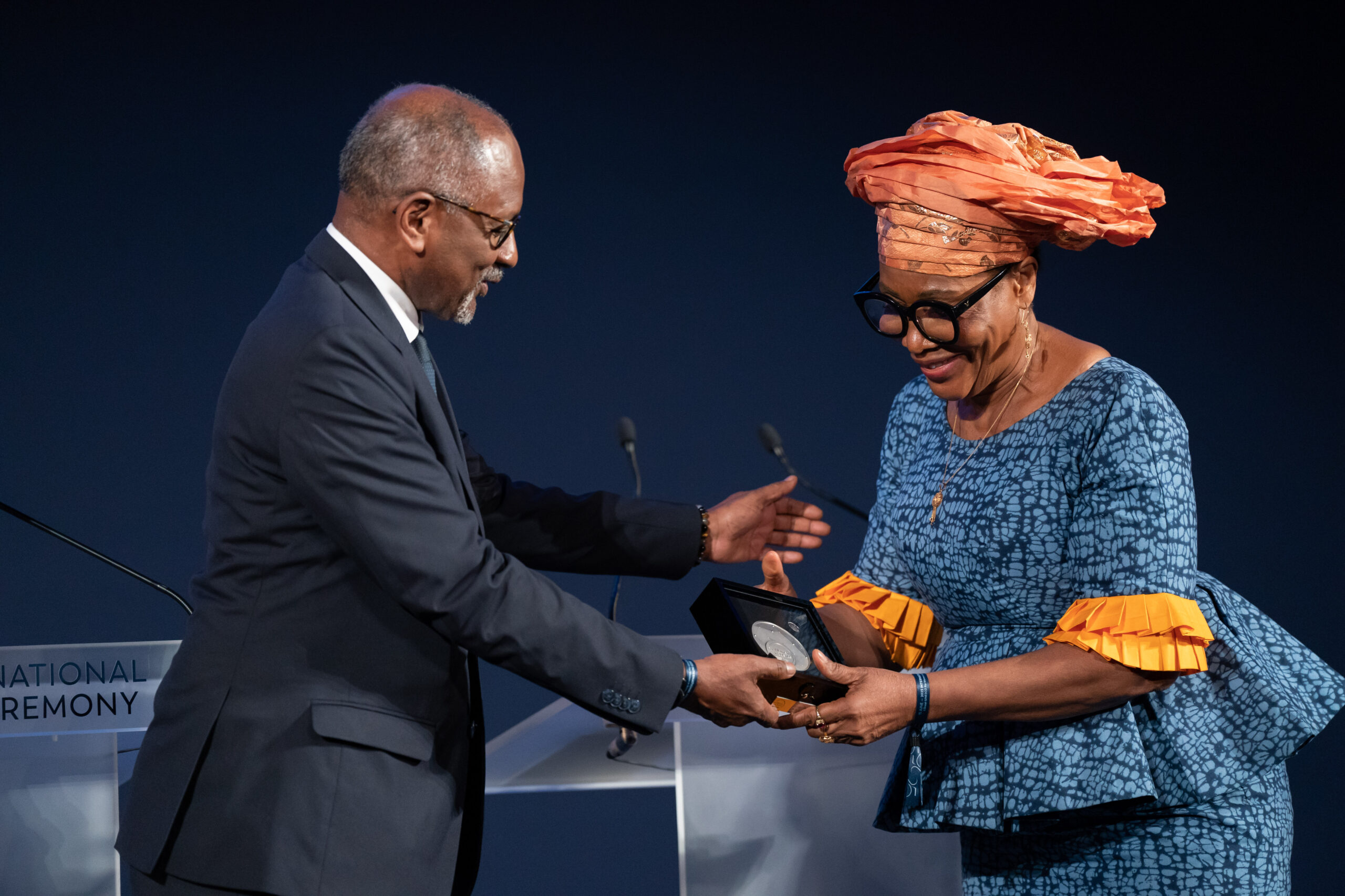 Dr. Marycelin Baba receives the L'Oréal-UNESCO Medal of Honor for Women Scientists from Firmin Edouard Matoko, Assistant Director-General for Priority Africa and External Relations of UNESCO.