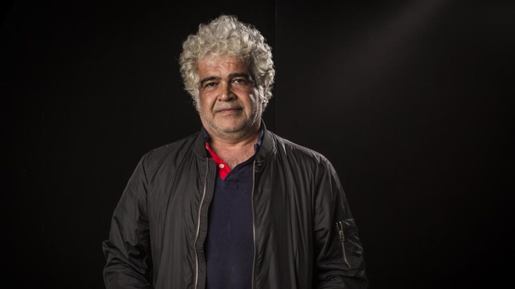 Renowned Syrian writer, Khaled Khalifa, stands in front of a dark backdrop.