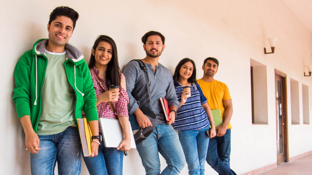 A group of Indian college students standing together on campus.